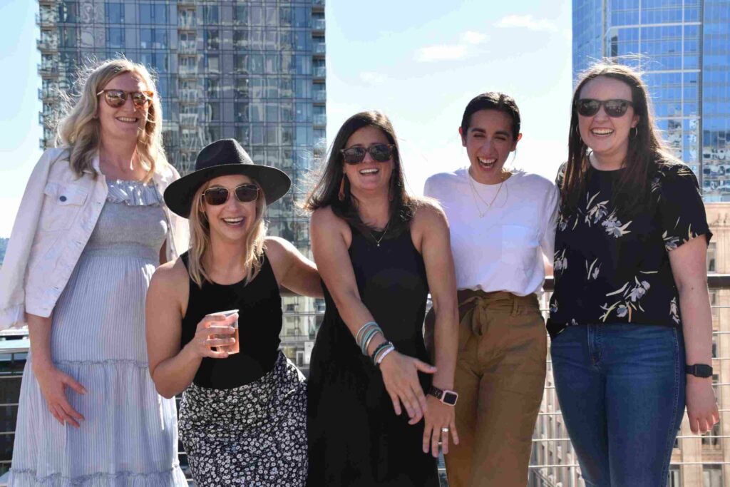 Evocalize team celebrating on a rooftop in downtown Seattle
