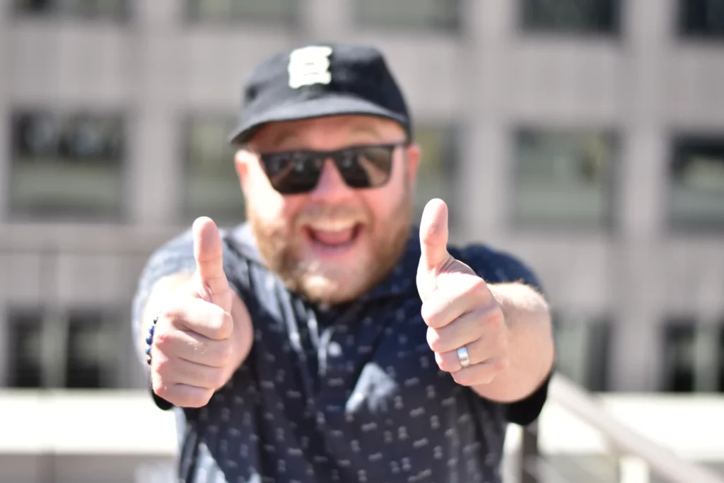 An Evocalize team member giving two thumbs up
