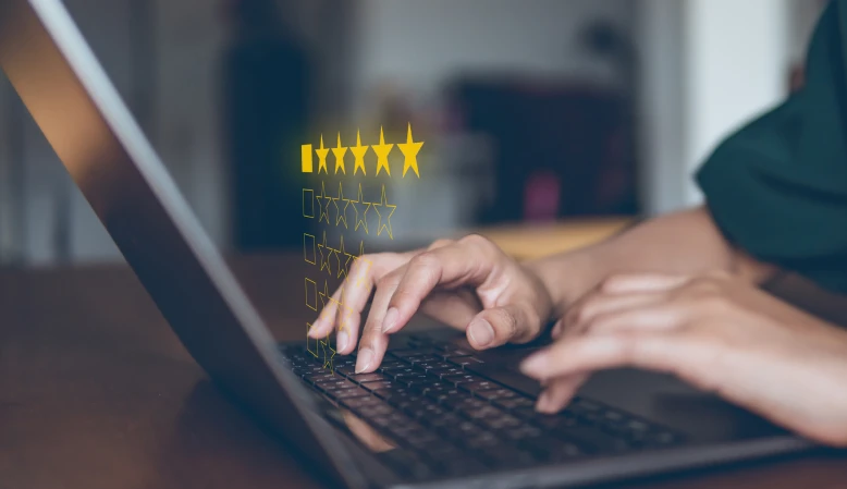 Person on a computer leaving a 5-star review.