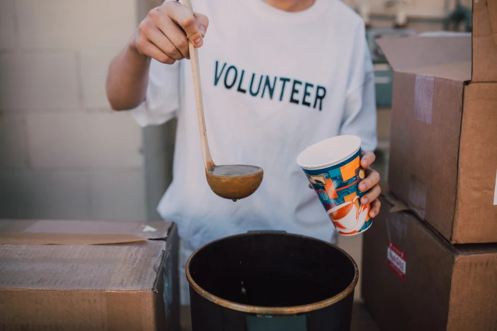 Volunteer serving soup