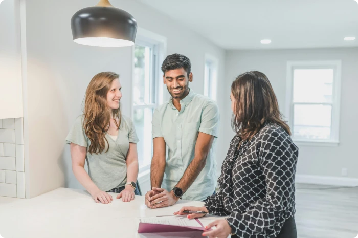 Couple talking with realtor. Tips for staying top of mind.