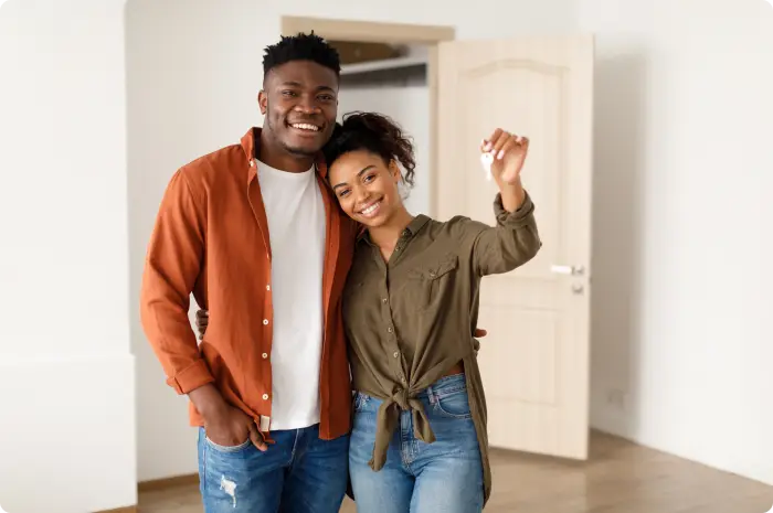 Couple buying a house and holding keys