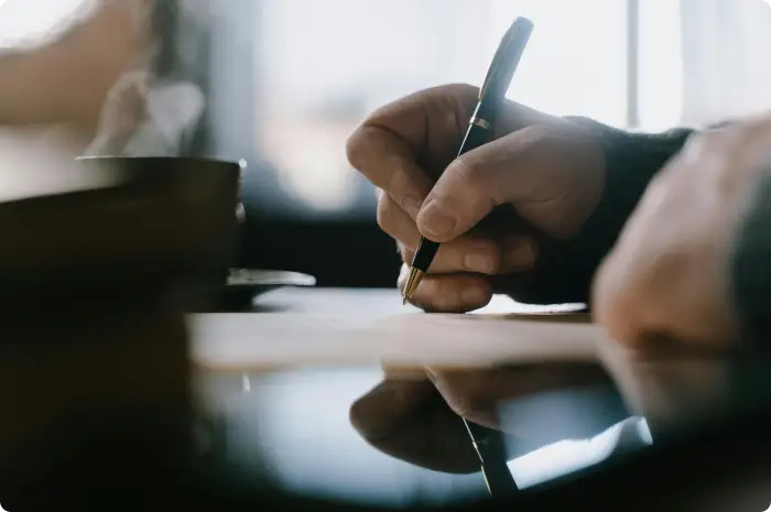 Person writing a handwritten note