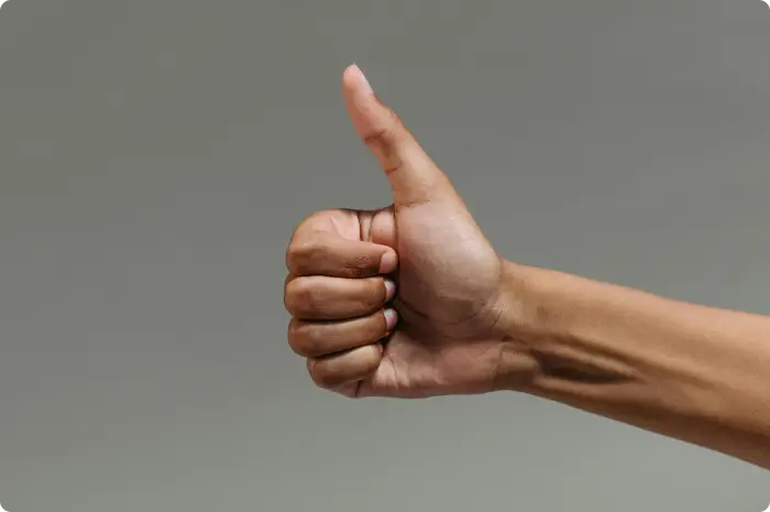 Person showing thumbs up approval